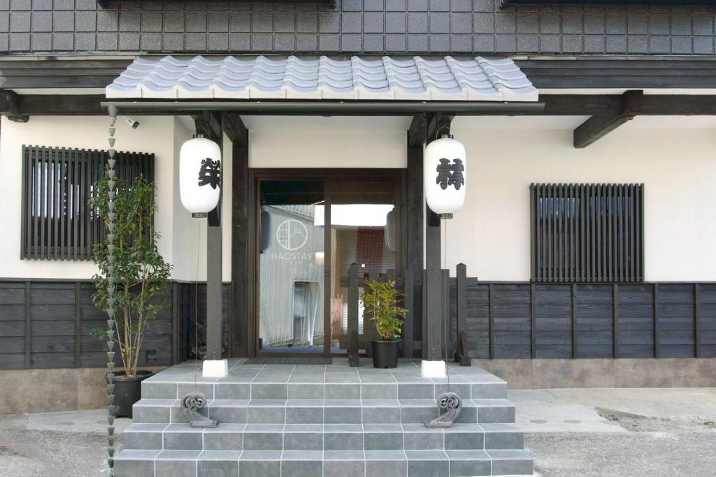 a front entrance to a house with a black gate at HAOSTAY Eirin in Fujikawaguchiko