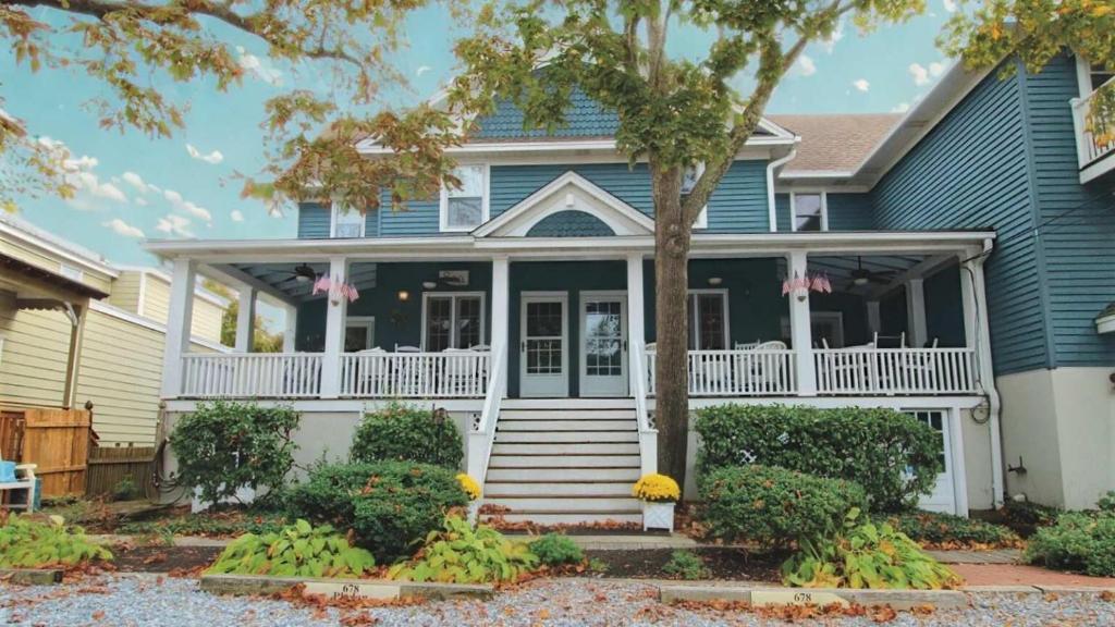a blue house with a white porch and white railings at Heritage House 2 in Cape May