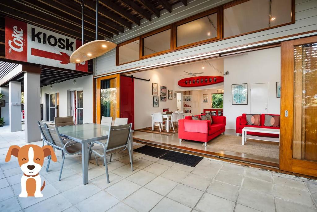a living room with a table and a dog sitting next to it at A AAA Coke Shack in Point Lookout