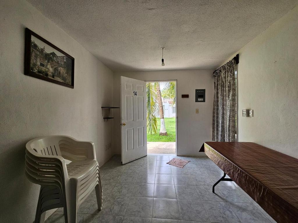 a room with a table and chairs and a door at Alojamiento en las Huertas in Barrio Nuevo
