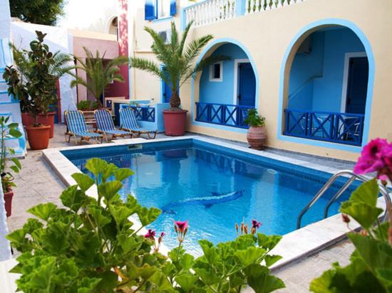 a swimming pool in front of a house at Unique Leta in Fira