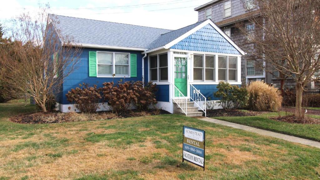 a blue house with a sign in front of it at 103 Broadway The Broadway Breeze in Cape May