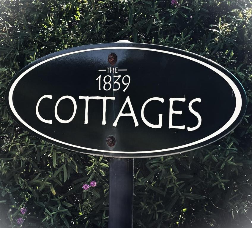 a sign that says the coffees at 1839 Cottages in Willunga