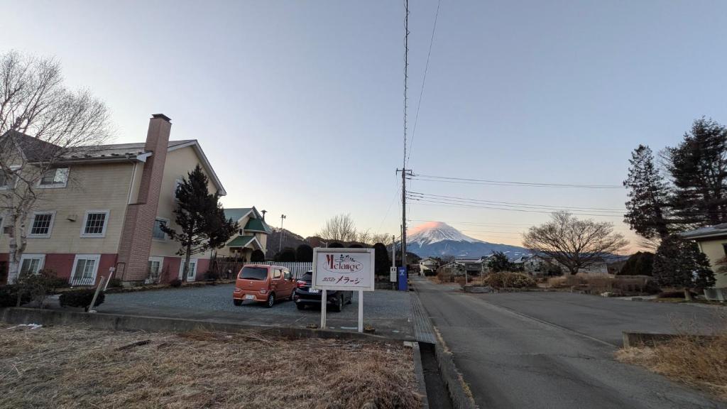 a sign in a street with a tax sign in front of a house at Gasthof Melange in Fujikawaguchiko