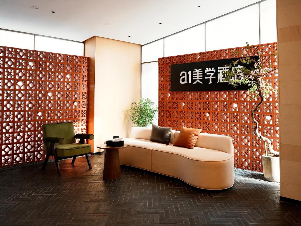 a living room with a couch and a chair at a1 Art Hotel in Quanzhou