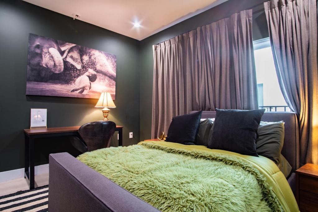 a bedroom with a bed and a large window at Emerald Elephas at Case Collective in North Hollywood