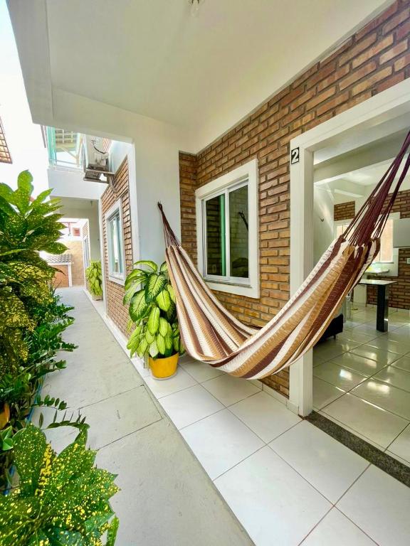 a hammock in a room of a house at Chalés Santo Antônio em Flecheiras in Flecheiras