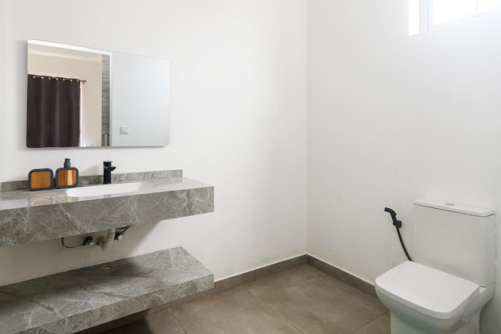 a bathroom with a sink and a toilet at Rocky 36 in Grand-Baie