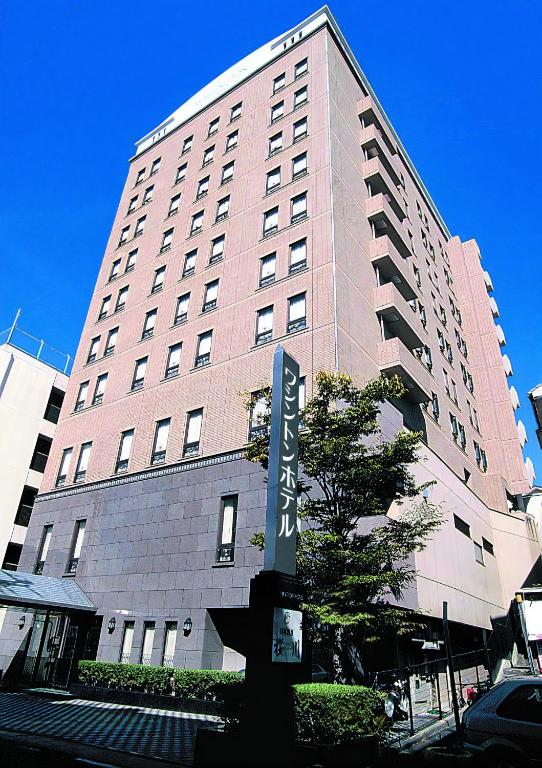 a tall building with a street sign in front of it at Sasebo Washington Hotel in Sasebo