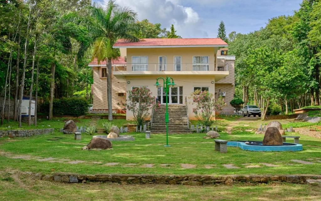 a house with a garden in front of it at The Temple Tree Residence in Yelagiri