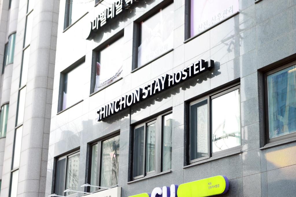 a building with a sign on the side of it at 더 신촌스테이 레지던스 in Seoul
