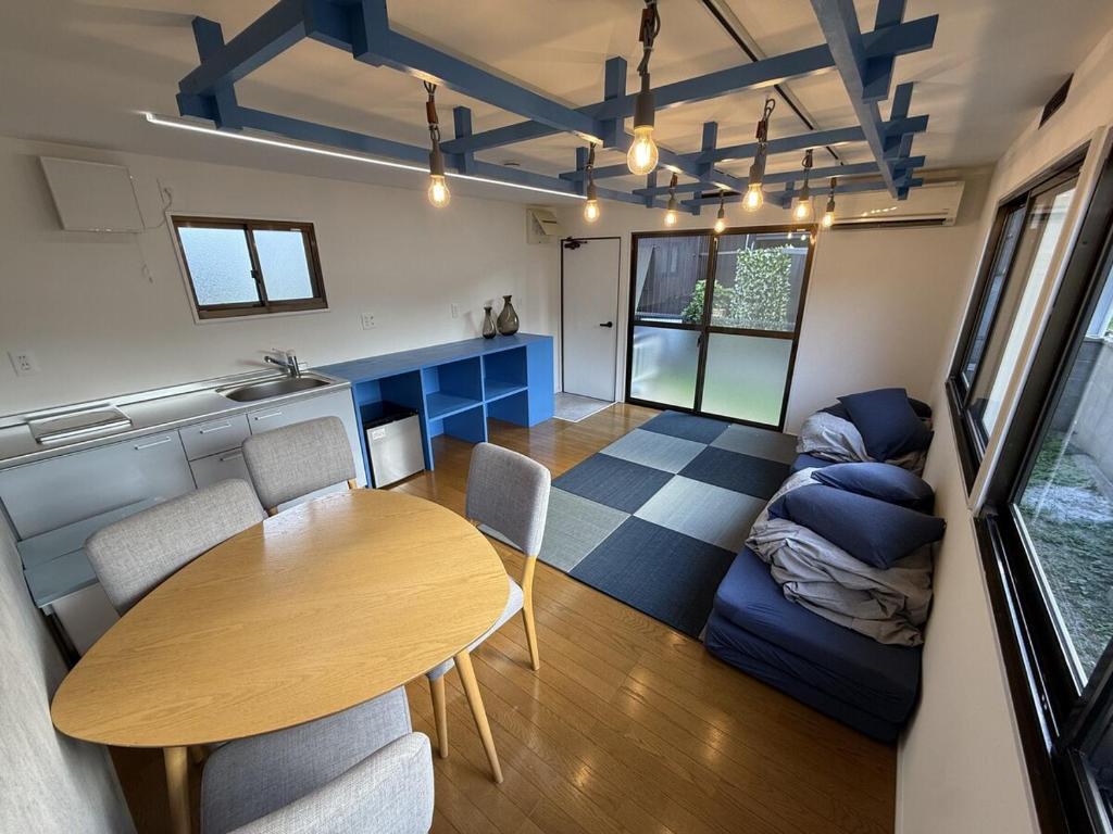 a living room with a table and a couch at Exsaison SETOUCHI in Sakaide