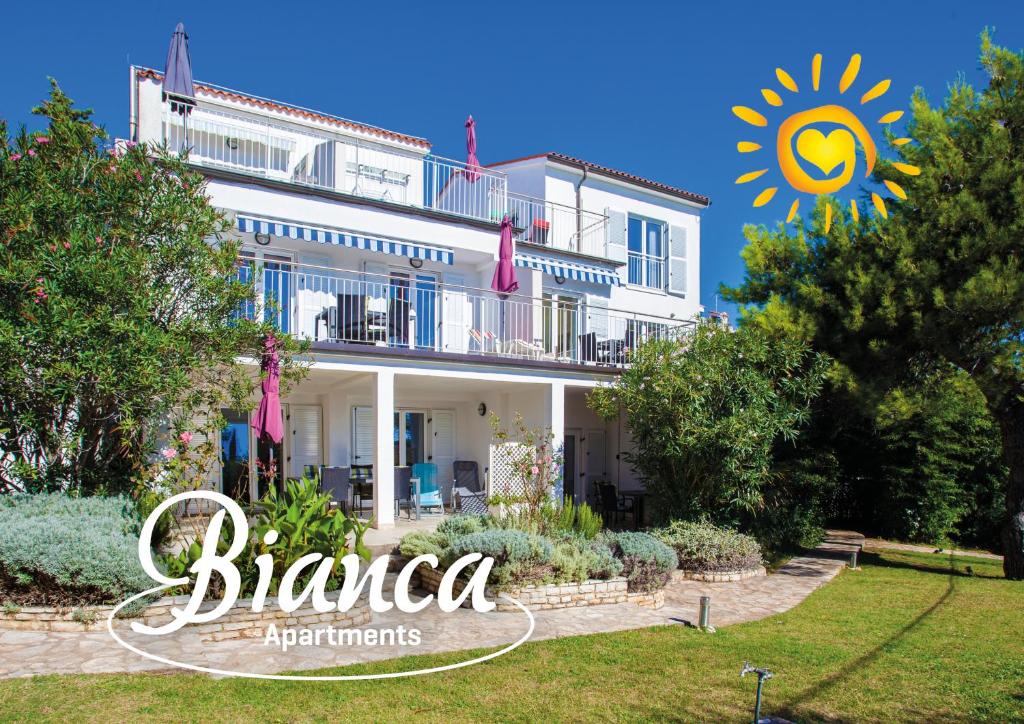 a villa with a garden and the logo for blanca apartments at Apartment Bianca Premantura Istrien in Premantura