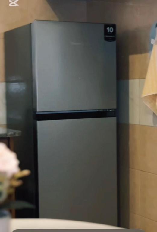 a stainless steel refrigerator in a kitchen at Malaika homes in Kampala
