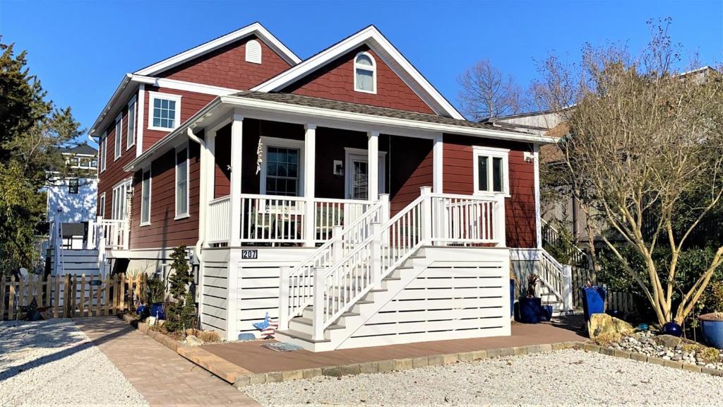 a red house with a white porch at Sail Away in Cape May Point