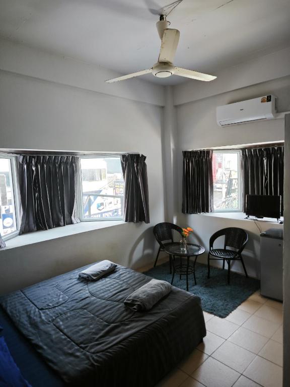 a bedroom with a bed and a table and chairs at TM Room For Rent in Pattaya