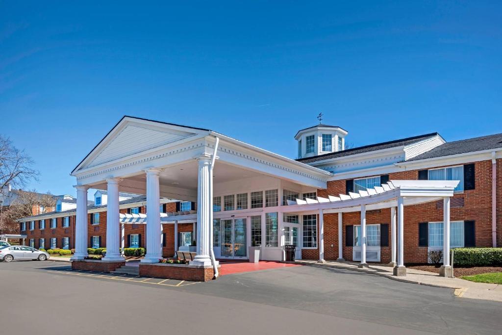 a large brick building with a tower on top of it at Clarion Hotel Conference Center Lexington North in Lexington