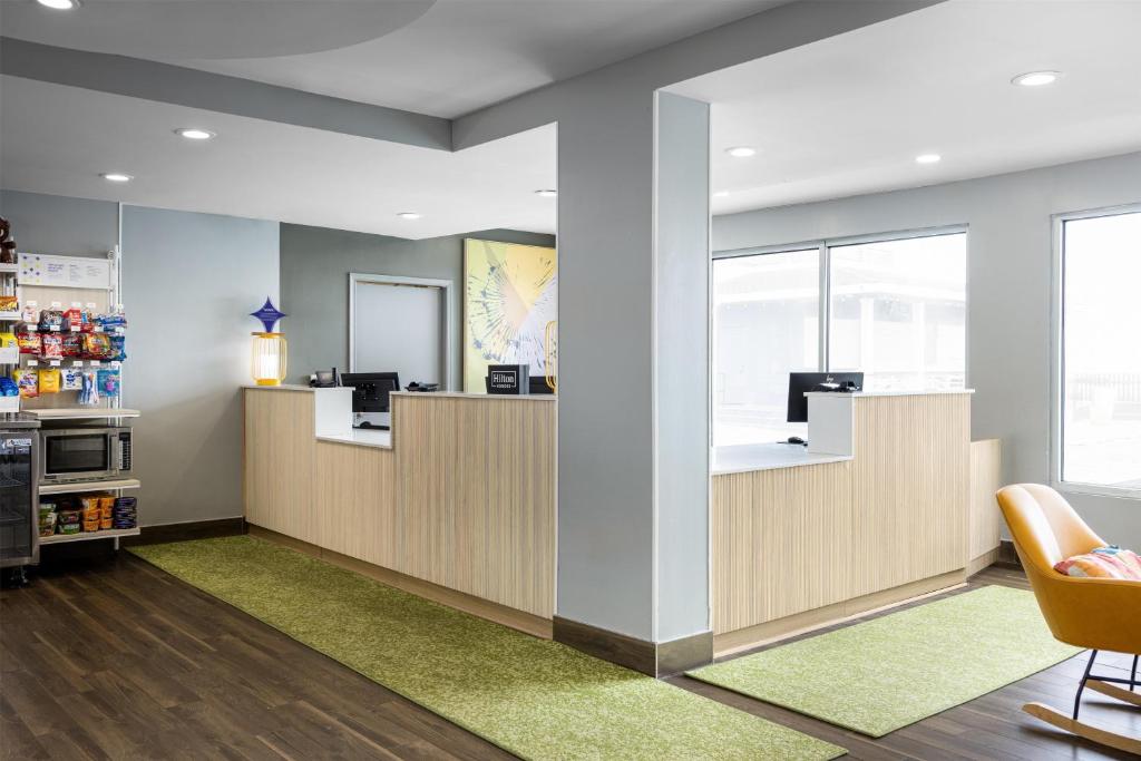 a waiting area in a dental office with a green rug at Spark by Hilton Virginia Beach Oceanfront in Virginia Beach