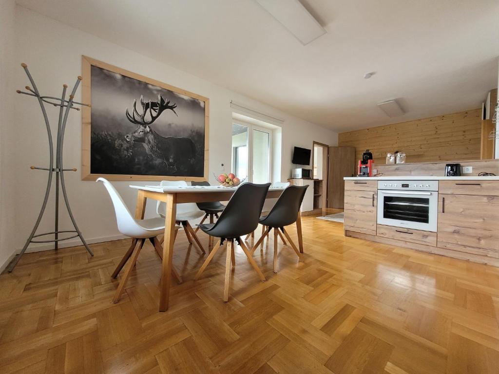 a kitchen and dining room with a table and chairs at Ferienwohnung Reich in Hirschegg Rein