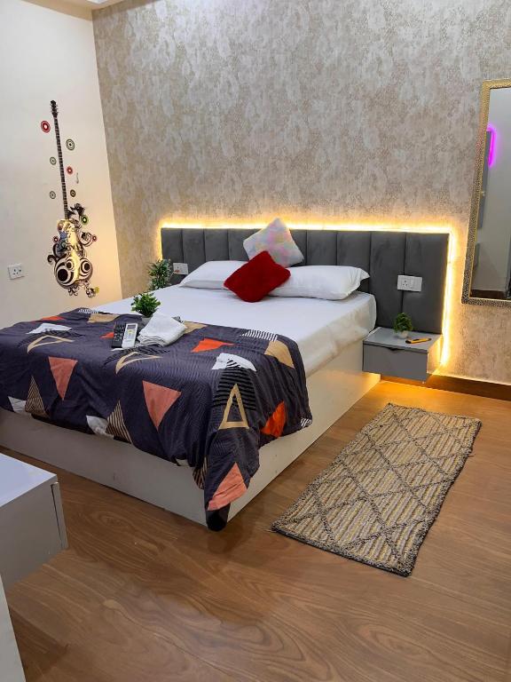 a bedroom with a large bed and a rug at Quantum stay 1 BHK couples family corporate in Noida
