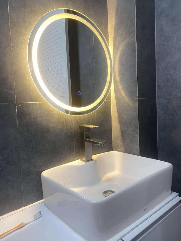 a bathroom with a white sink and a mirror at Balay Buenavista in Magdalena