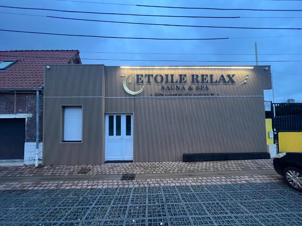 a building with a sign on the side of it at Étoile relax in Douai