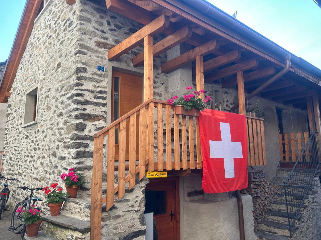 a house with a flag on the side of it at Casa Majagatt Holiday Home in Roveredo