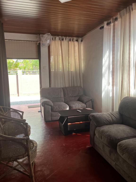 a living room with a couch and a table at Maria Ceylon Villa in Tangalle