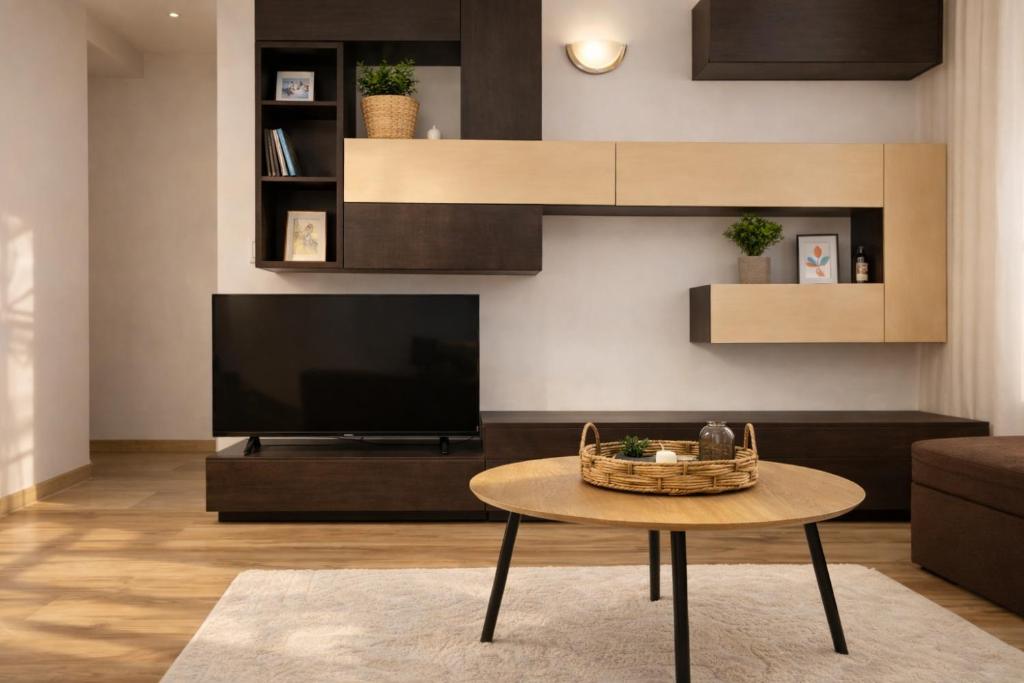 a living room with a table and a television at RNR Airport 3 in Otopeni