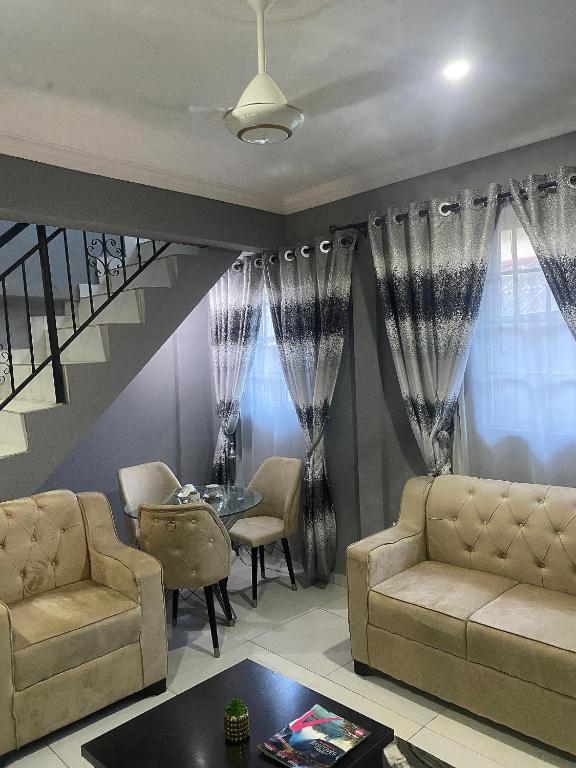 a living room with a couch and a table at E&V APARTMENT Berger Express in Iseri-Oke