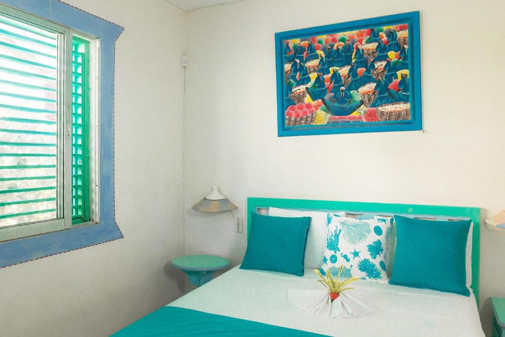 Una cama o camas en una habitación de Hotel Playa Colibri