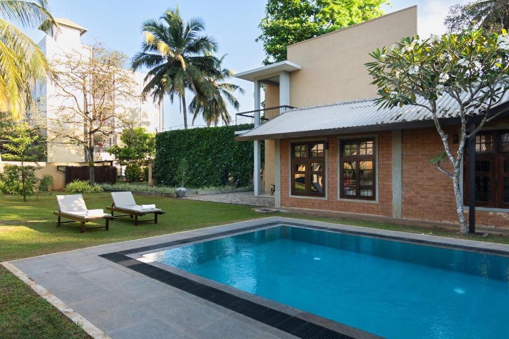 a swimming pool in the yard of a house at Divulgaha Gedara Boutique Hotel in Anuradhapura