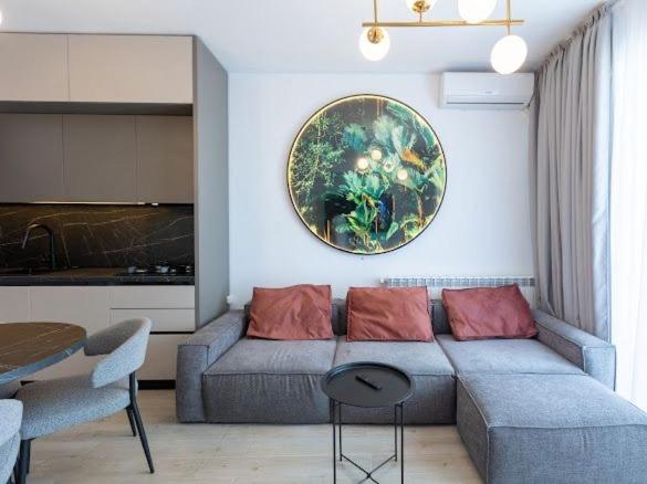 a living room with a couch and a plate on the wall at Apartament Lara mamaia in Mamaia Sat/Năvodari