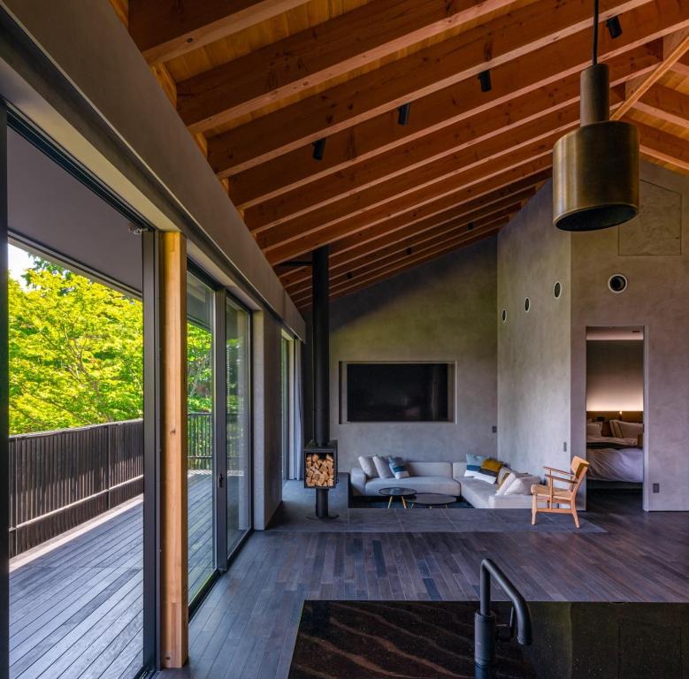 an open deck with a living room and a couch at MONS GORA Luxury Private Villa with Onsen Hakone Gora in Hakone