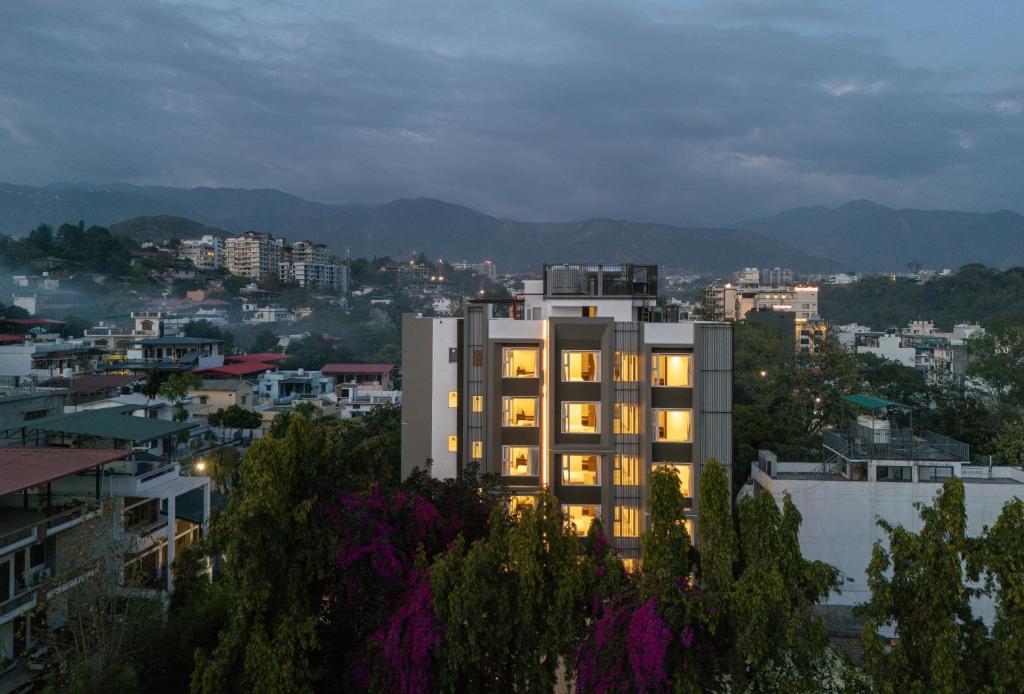 a building with its lights on in a city at Hotel HiStays, Dehradun in Dehradun