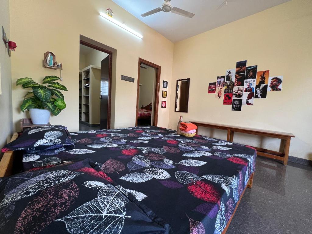a bedroom with a bed with a quilt on it at Geetham Homestay in Tiruchirappalli