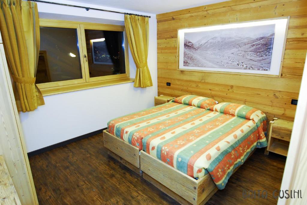 Postel nebo postele na pokoji v ubytování Residence Baita Cusini