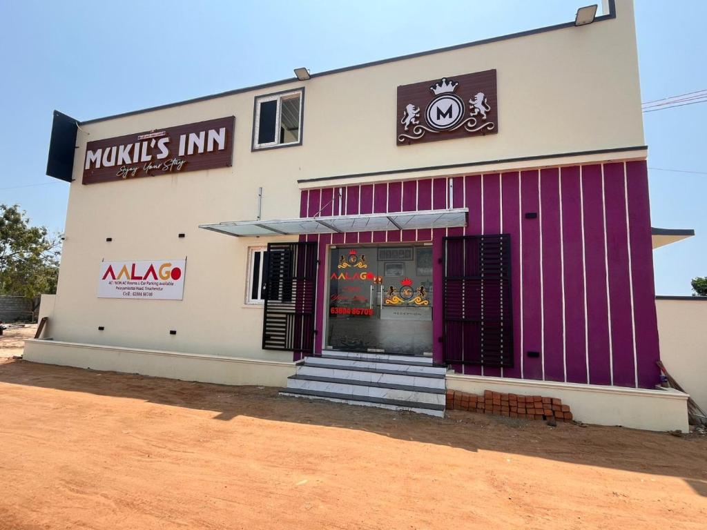 a mcdonalds restaurant with purple doors on a building at AalaGo in Thiruchendur
