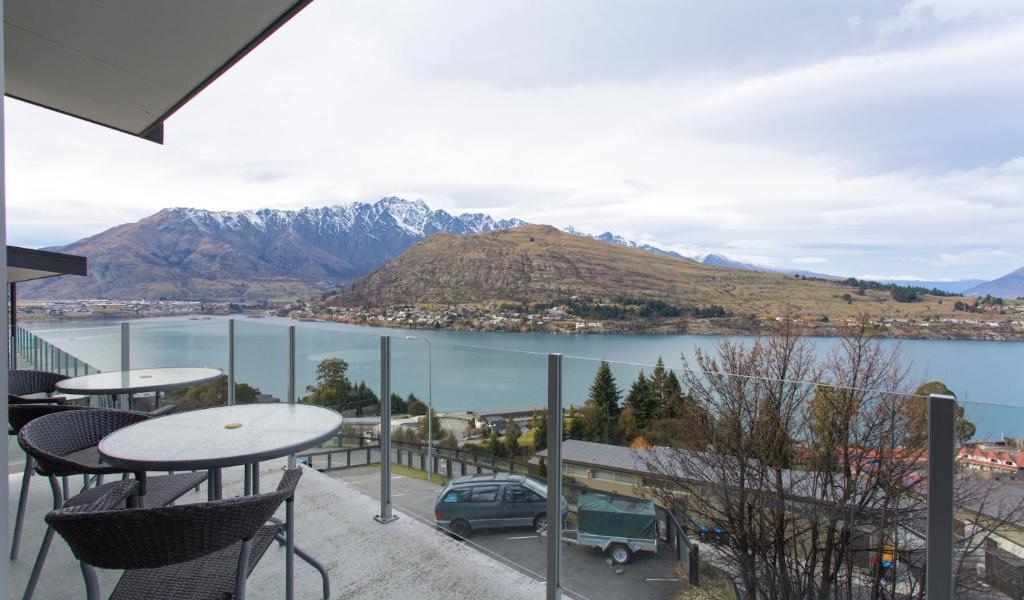 a balcony with a view of a lake and mountains at Goldrush # 2 in Queenstown