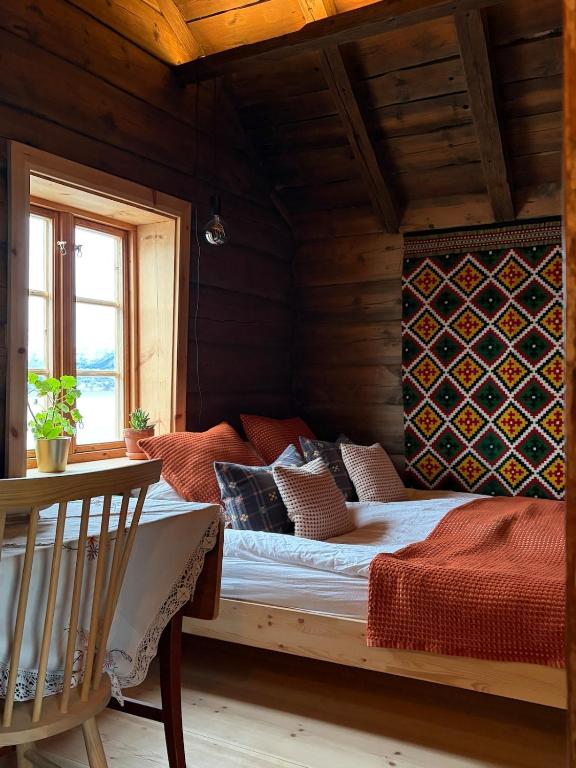 a bedroom with a bed in a wooden room at Urastova in Vassenden