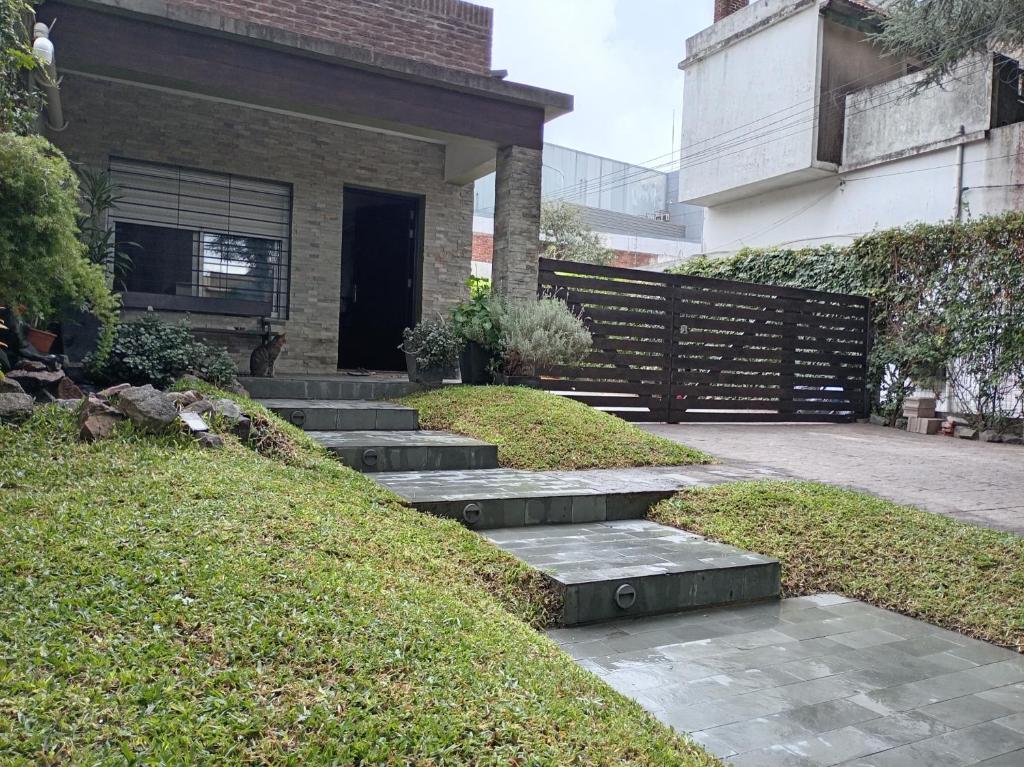 a set of stairs leading to a house at La Pinta Càlida casa en Malvìn con cochera in Montevideo