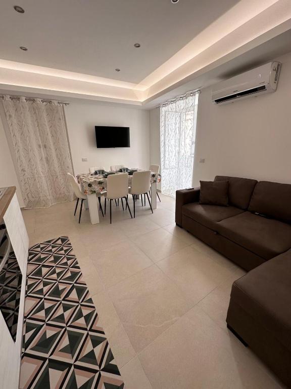 a living room with a couch and a table at Lo duca luxury home in Cefalù