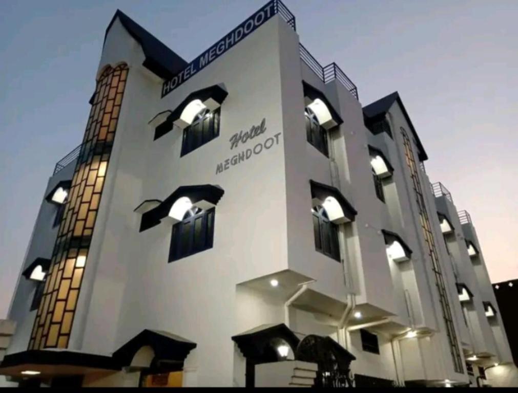 a large building with windows and lights on it at Hotel Meghdoot in Bhadohī