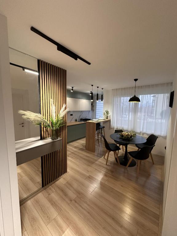 a dining room and kitchen with a table and chairs at Urban Studio 018 in Niš