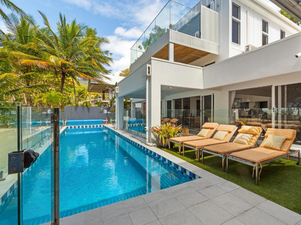 an image of a house with a swimming pool at Tenterfield Beachfront Luxury 4 Bedroom Holiday Home in Oak Beach