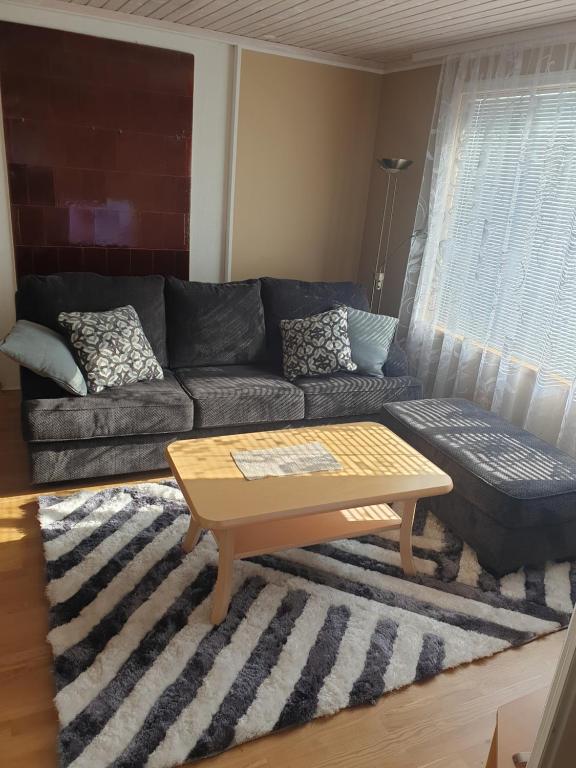 a living room with a couch and a coffee table at Kuressaare Centrum in Kuressaare