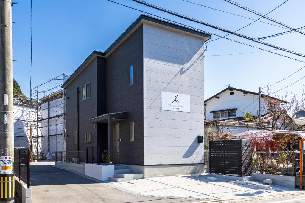 a black and white building on a city street at YAMAKATSU Hotel in Dazaifu