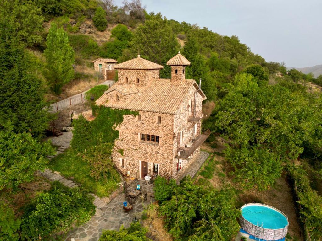 an aerial view of a house on a hill at Las Casas del Nogal - Guesthouse en Sierra Nevada in Güéjar-Sierra