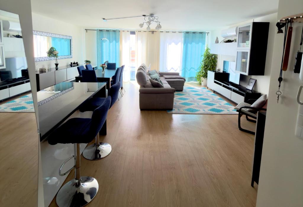 a living room with a kitchen and a living room with a couch at Casa Ponte do Mar in Sines