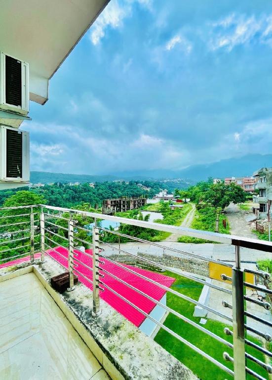 a balcony with a view of a city at Sukoon in Jāmb